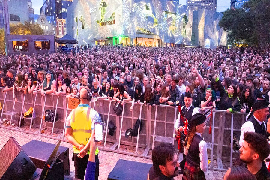 Crowd control barricades and security setup at large conference entrance